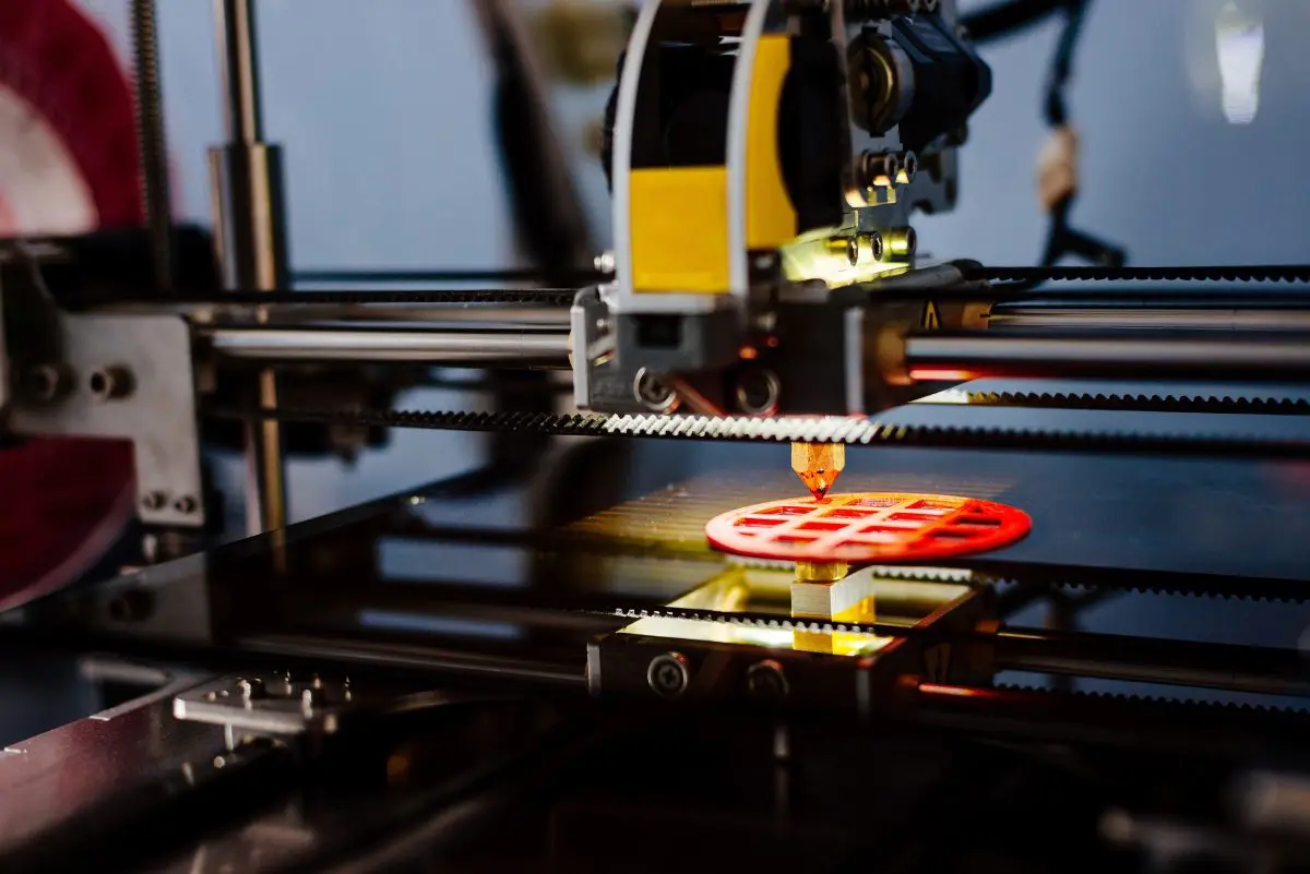 3D printer creating a red object.